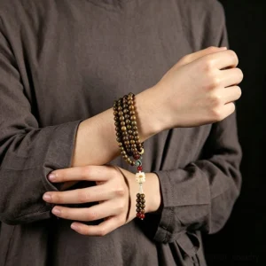 Buddhist prayer mala detail shot showcasing green sandalwood bead texture and craftsmanship