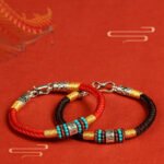 Pair of red and black Buddhist string bracelets with Om Mani Padme Hum mantra beads and 925 sterling silver charms