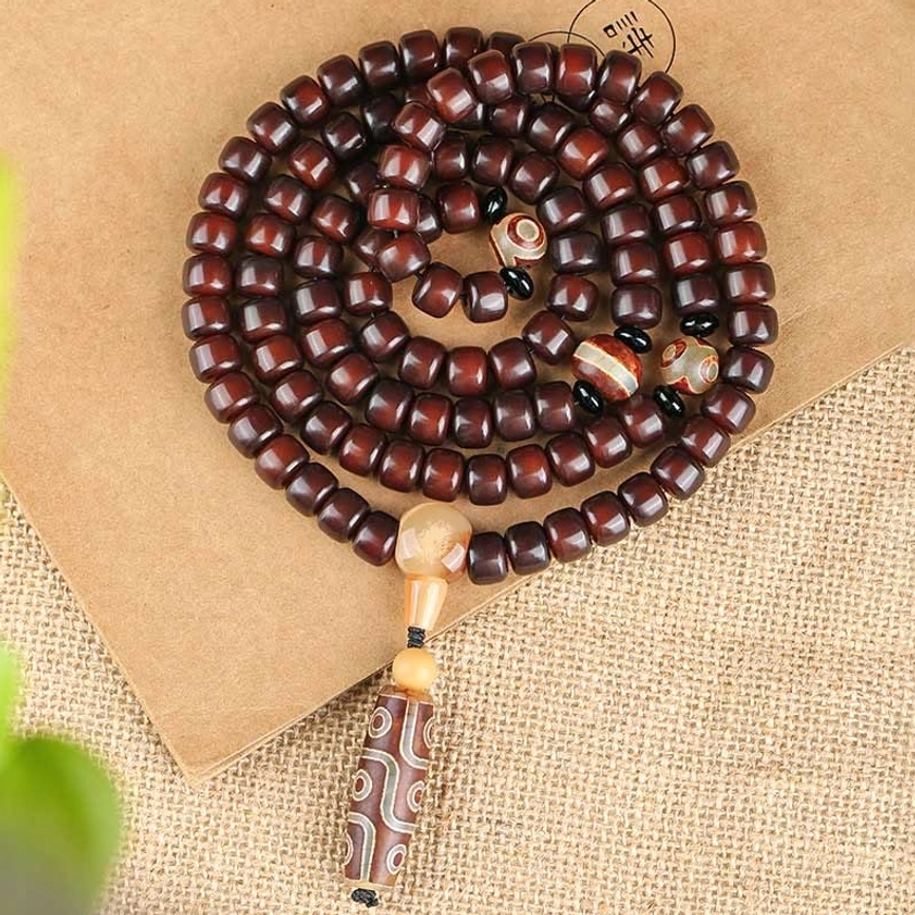 108 bead mala prayer bracelet with dzi stones and jade beads stacked display, flat lay showing complete handmade Buddhist jewelry piece for spiritual practice
