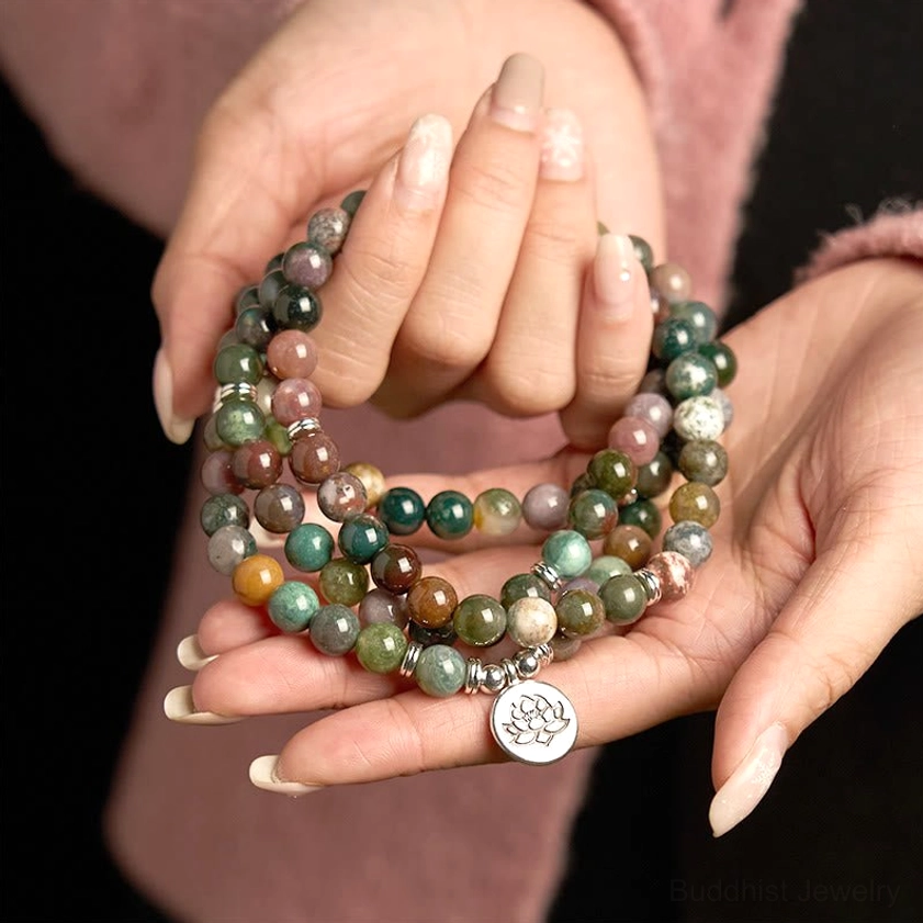 Hand holding 108 Indian agate mala beads prayer bracelet with lotus pendant charm