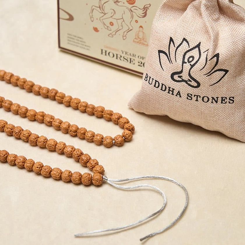 Complete Bodhi seed mala beads set with Buddha Stones cloth bag packaging showing brown beads silver tassel and branded pouch