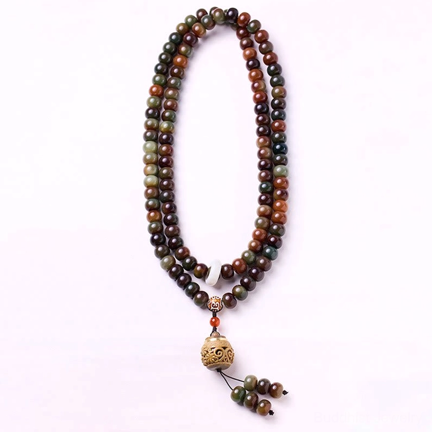 Full 108 bodhi seed mala beads loop with carved wooden pendant and tassel, flat studio minimalist background