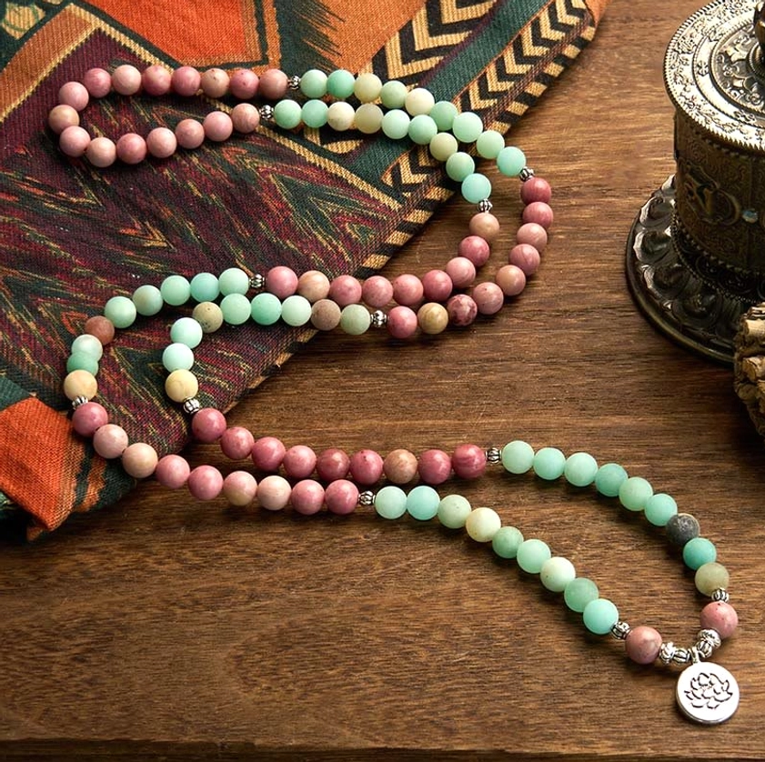 Long strand of 108 bead mala beads showing dual-color rhodonite pink and amazonite aqua with silver lotus charm accent
