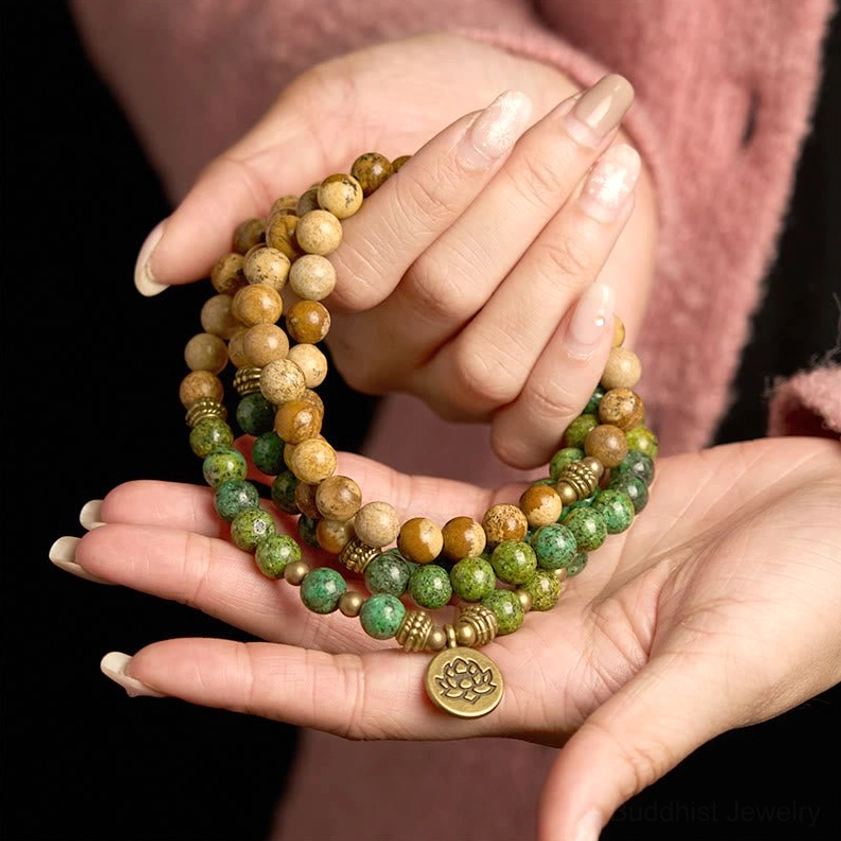 Front close-up of 108-bead Buddhist mala bracelet showing complete beaded strand with lotus pendant detail