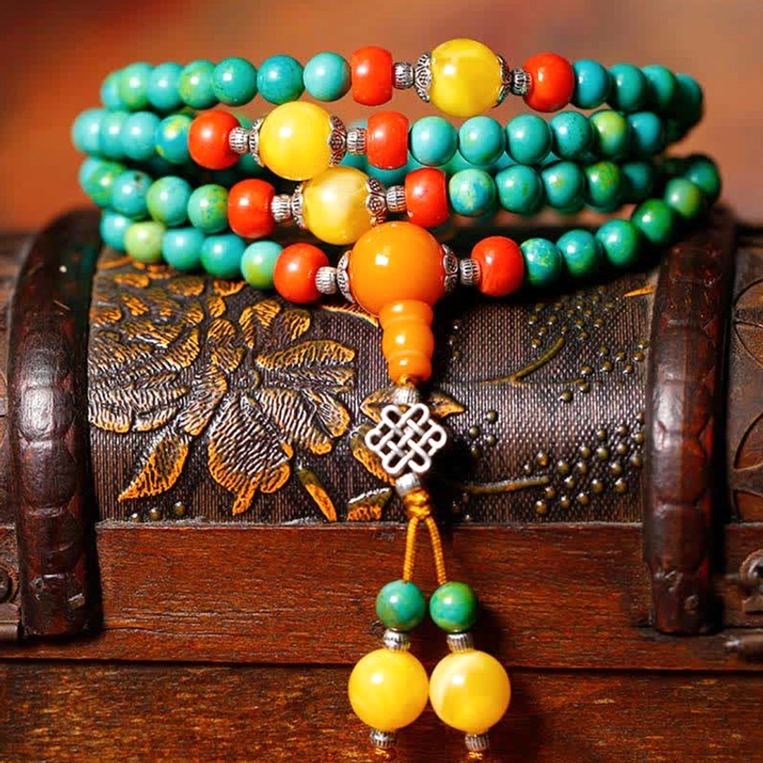 108 Buddhist prayer mala bracelet with turquoise beads and protective dzi stone detail shot