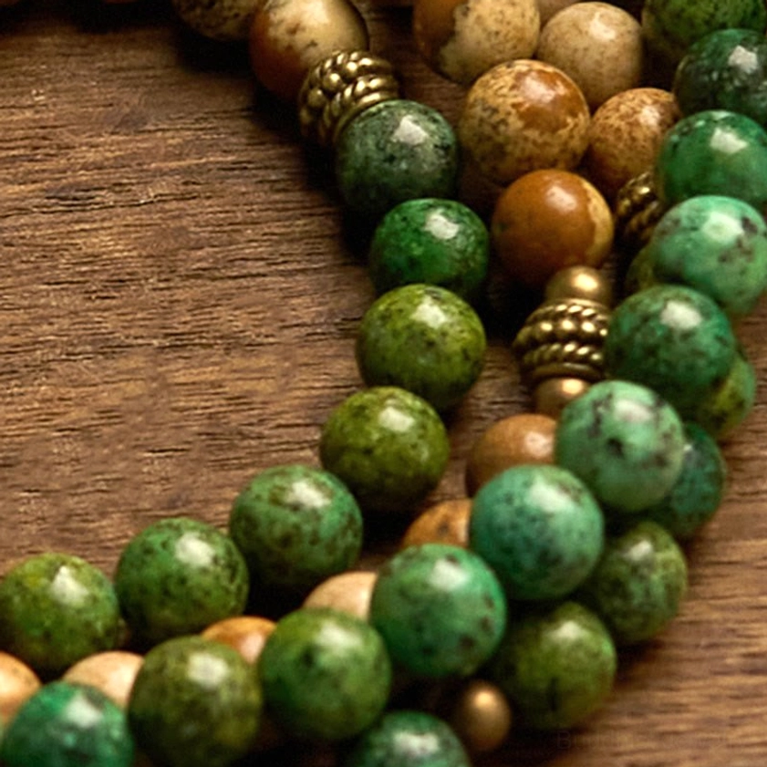 Top-down macro view of 108-bead mala showing mixed brown picture jasper and green turquoise stone beads