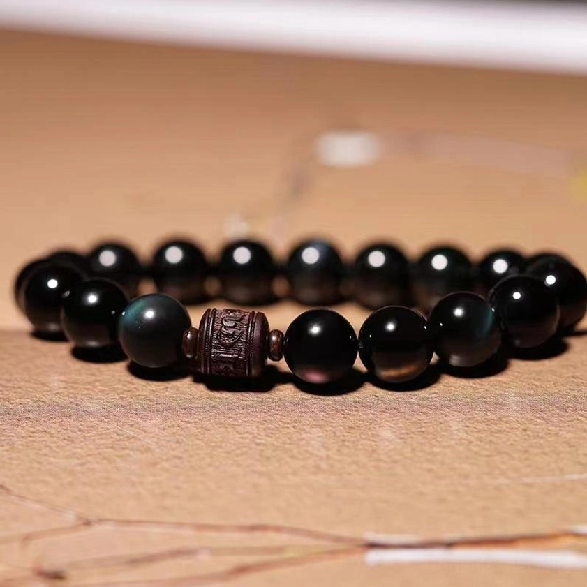 12mm Rainbow Obsidian Om Mani Padme Hum bracelet showing iridescent blue green purple sheen under light
