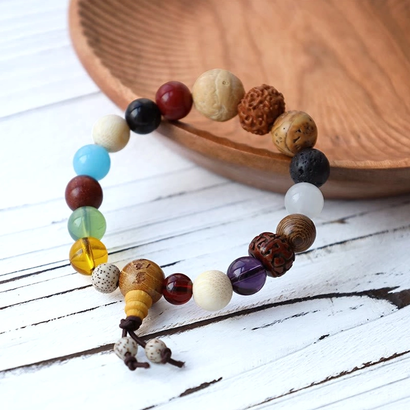 Natural multi-bead Buddhist wrist mala bracelet featuring Bodhi seeds, gemstones, and tassel charm