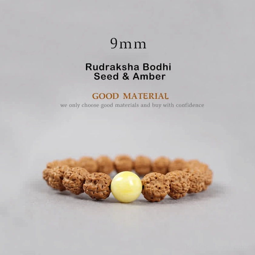 9mm Rudraksha Bodhi Seed and Amber bracelet flat lay featuring brown textured seeds with smooth golden yellow amber bead accent
