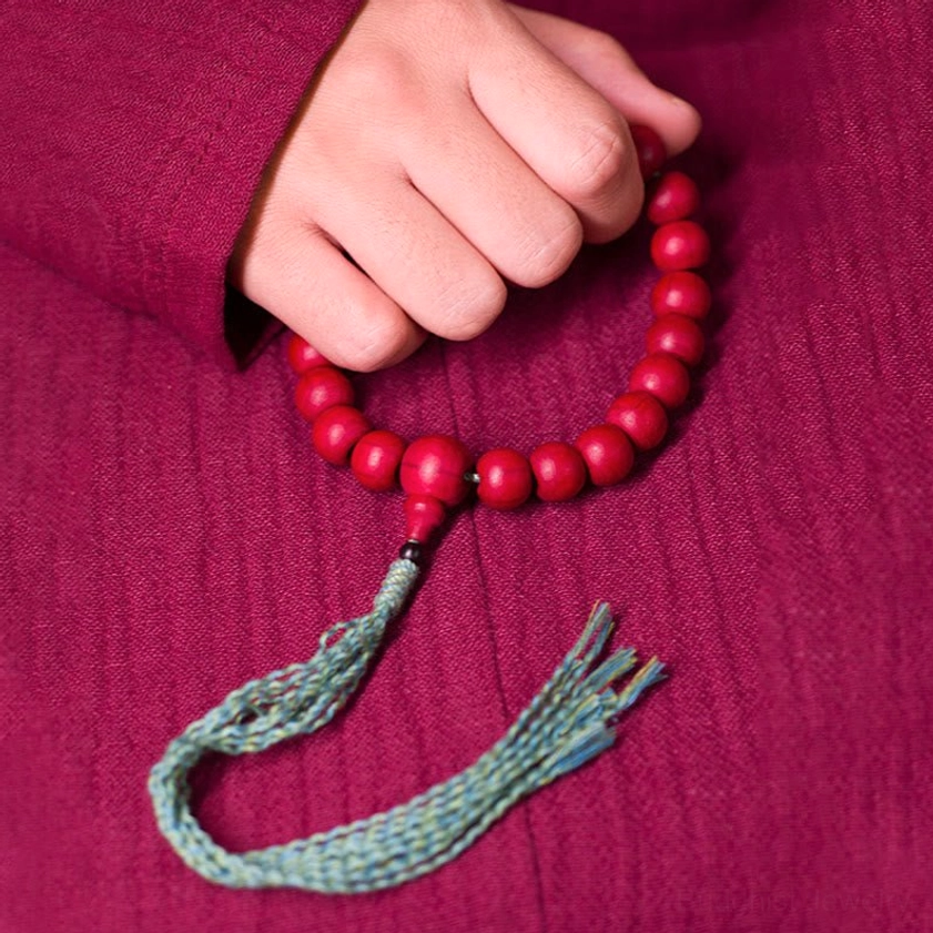 Abelia Biflora wood 10mm 12mm 15mm Buddhist prayer mala bracelet with teal tassel overhead view