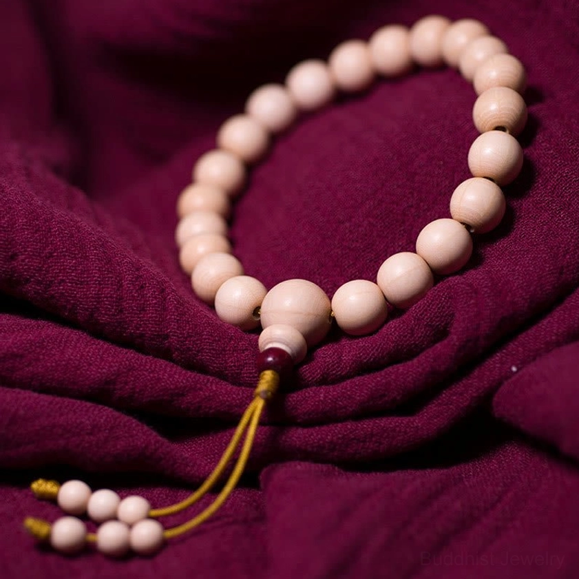 Full 21-bead Abelia Biflora wood Buddhist mala bracelet overhead flat lay with hanging tassel