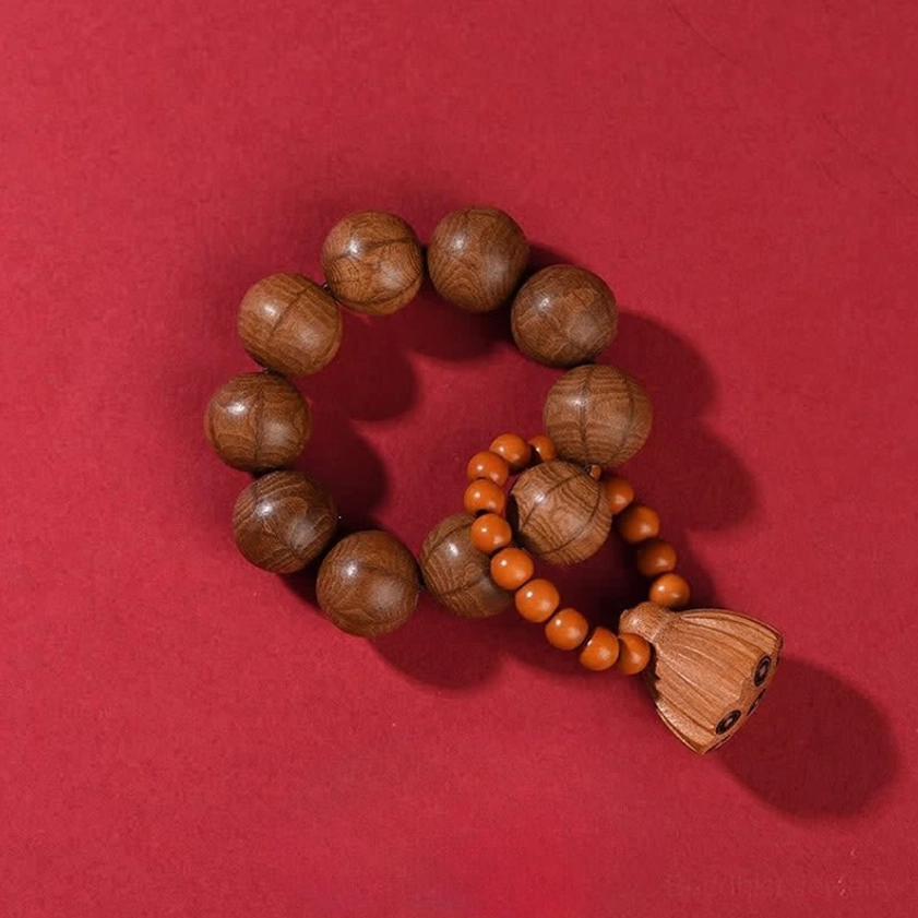 Abelia Biflora meditation mala beads close-up showing six-line natural texture dragon wood beads with lotus pod charm for Buddhist spiritual practice