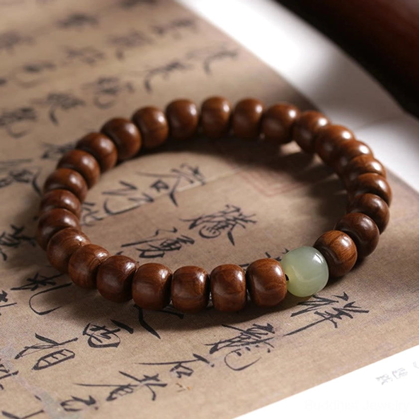 Abelia wood hetian jade bead bracelet six by eight millimeter size variation displayed on neutral background