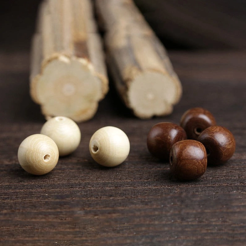 Round abelia wood beads with bamboo-like jade bead segments displayed overhead on dark wooden table