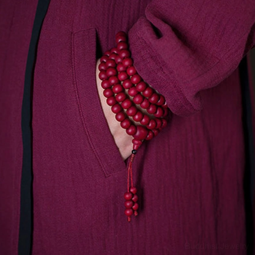 Abelia wood mala bracelet worn on wrist showing stacked beads and knotted tassel accessory