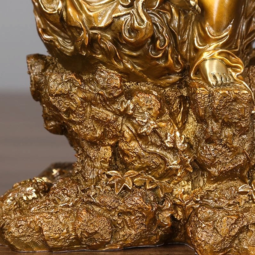 Low-angle close-up of Acalanatha Buddha statue base showing realistic stone-like carved texture and seated foot