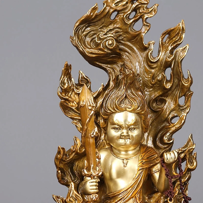 Close-up detail of Acalanatha Buddha's face and flame aureola showing fierce compassion expression and intricate carving
