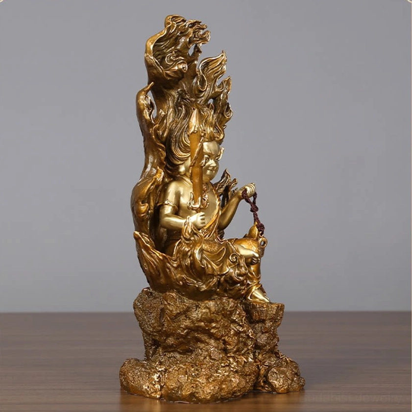 Left side view of Acalanatha Buddha handcrafted copper statue showing seated pose with prayer beads cord