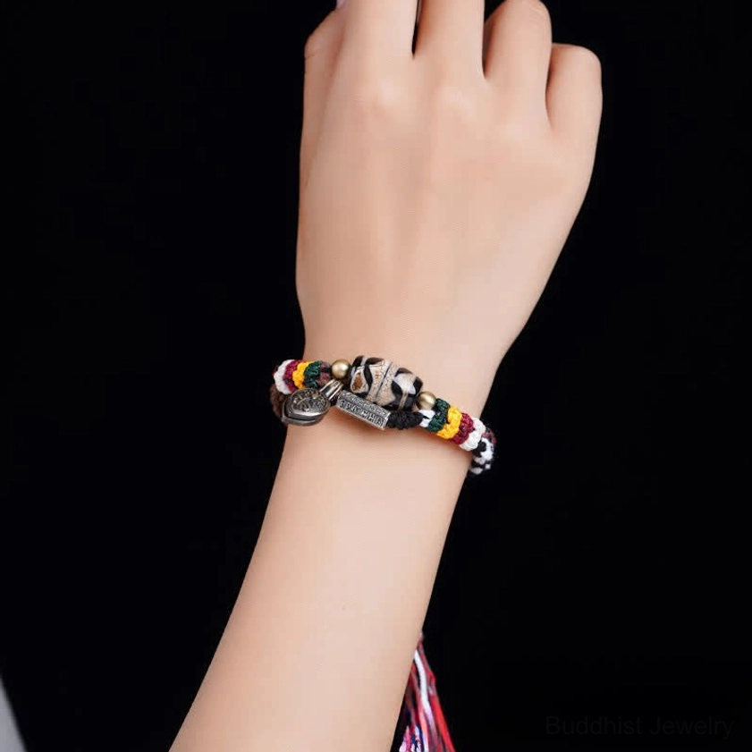 Adjustable Buddhist dzi bead bracelet showing sliding knot mechanism for wrist circumference fitting