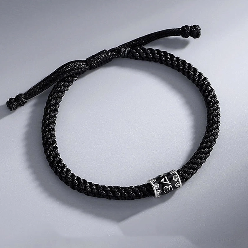 Adjustable Buddhist bracelet full view with pull-knot closure and engraved silver barrel bead detail