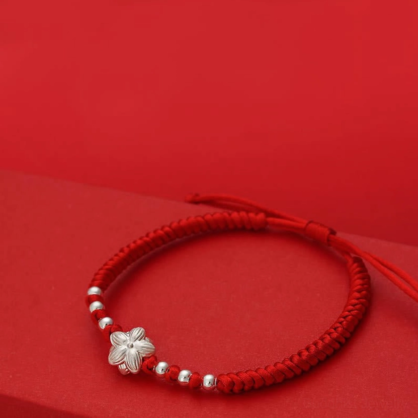Adjustable red string bracelet with sliding knot closure, minimalist braided design