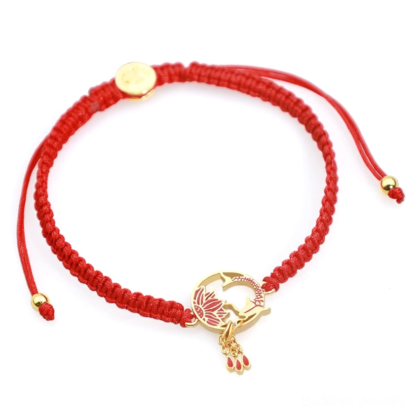 Adjustable red string bracelet with sliding bead adjusters and hollow koi-lotus metal charm, top-down view on yellow background