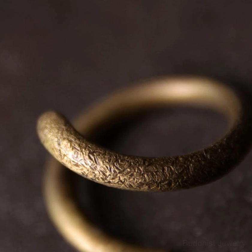 Copper spiral ring macro close-up, rough surface texture, thick handcrafted metal band