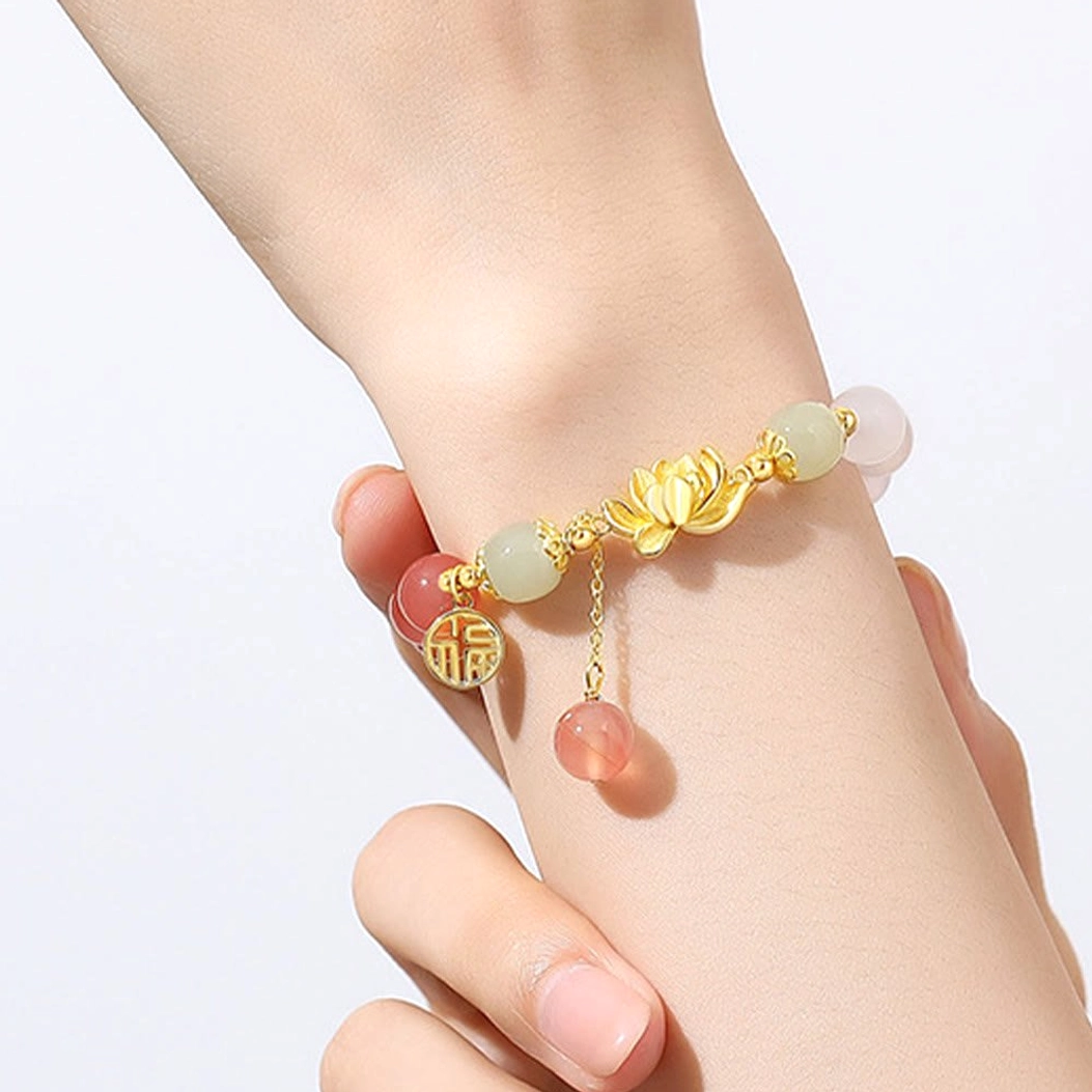 Woman wearing gradient agate Hetian jade Buddhist bracelet on wrist, showing fit and comfort with lotus charm visible