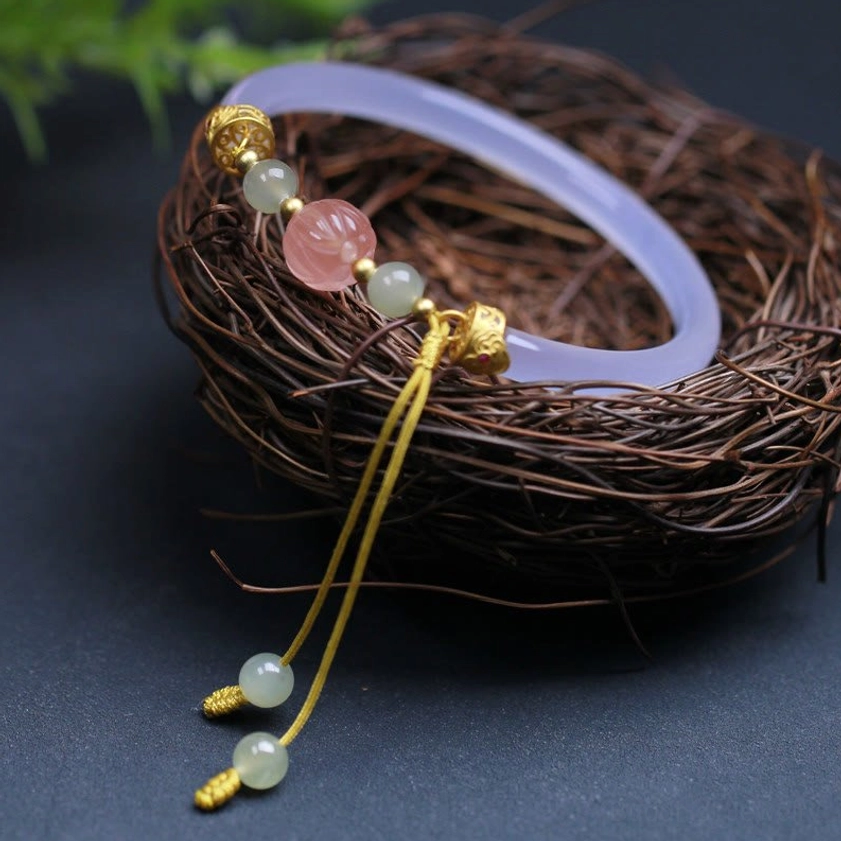 White agate lotus Buddhist bracelet arranged in decorative bird's nest with flowing tassel charm