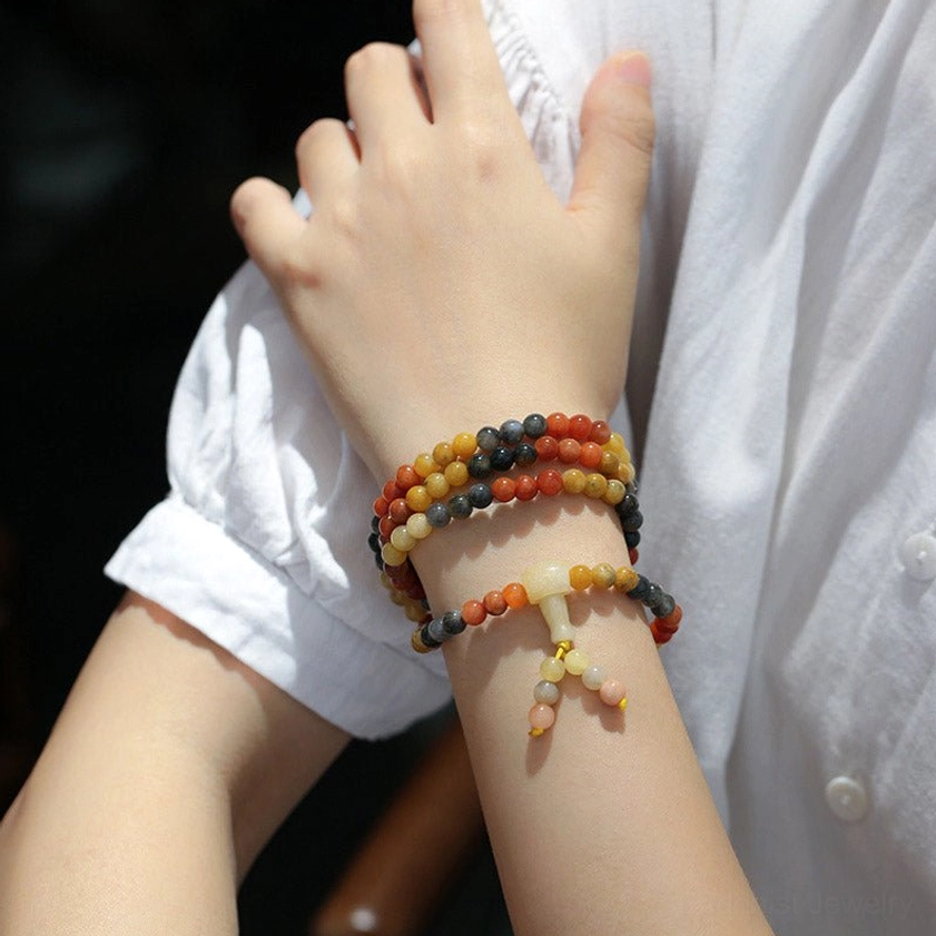 Agate mala bracelets worn on dual wrists showing how 108 bead prayer bracelet looks when worn - lifestyle shot