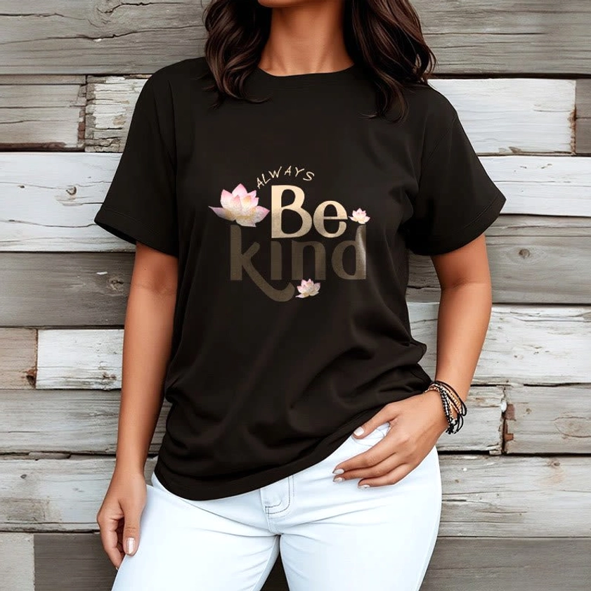 Female model wearing black Always Be Kind Buddhist T-Shirt paired with white jeans, wooden wall background