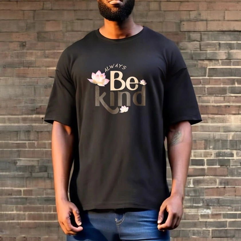 Male model wearing black Always Be Kind Buddhist T-Shirt with blue denim jeans, brick wall background