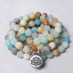 Amazonite lotus prayer mala with 108 beads in overhead flat lay, showing mixed blue and earthy tone stone beads with silver lotus charm and spacers