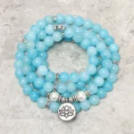 Amazonite lotus mala bracelet 8mm beads with silver spacers and lotus charm on textured surface