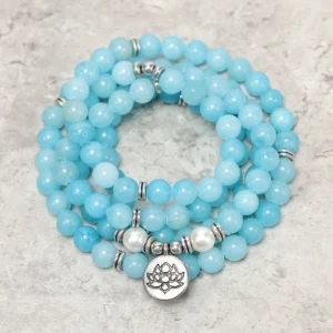 Amazonite lotus mala bracelet 8mm beads with silver spacers and lotus charm on textured surface