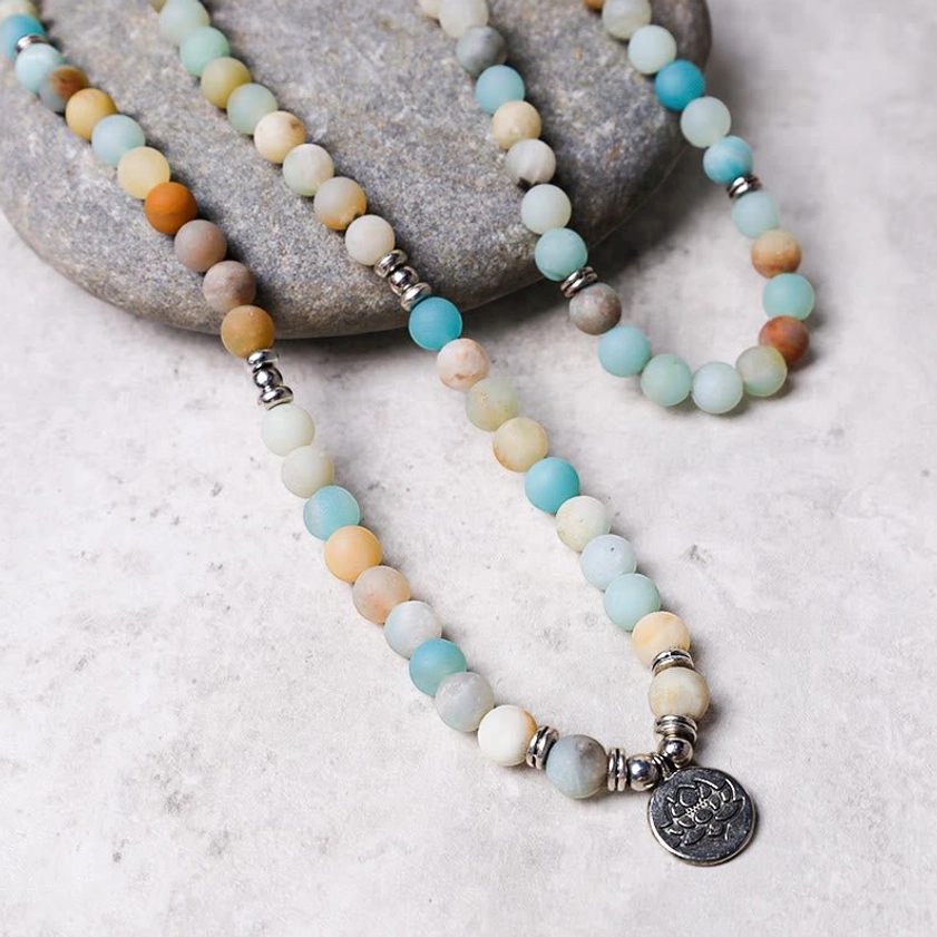 Amazonite buddhist prayer mala necklace side view, displaying strung multi-tone matte stone beads with silver lotus pendant charm