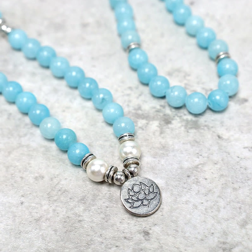 Loose amazonite mala strand showing individual 8mm round beads with silver spacer rings