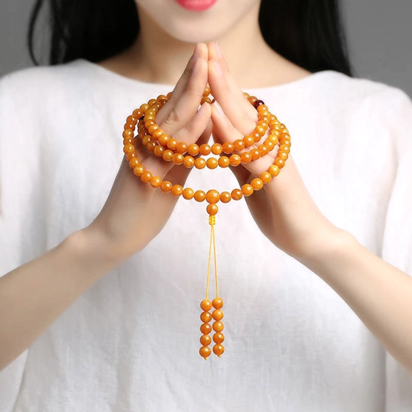 Amber 108-bead Buddhist prayer mala bracelet with elastic cord and protective spacer beads