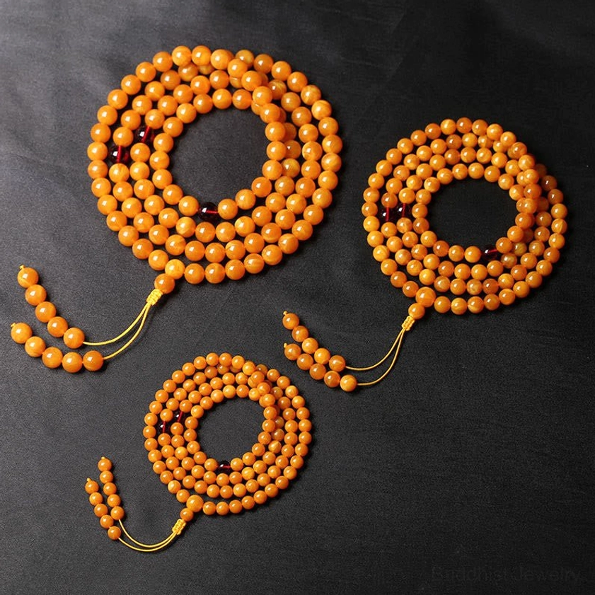Three sizes of amber prayer mala beads displayed, showing 6mm 8mm 10mm bead options for Buddhist meditation practice
