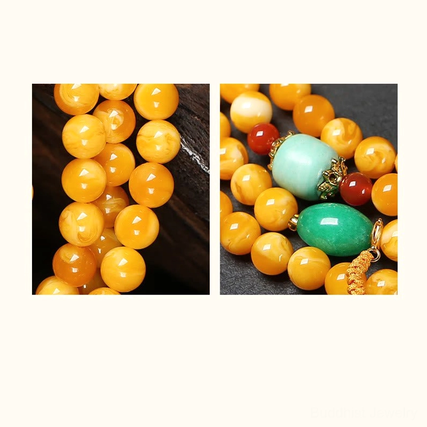 Macro detail of amber bead texture and turquoise gemstone accents on Buddhist mala necklace