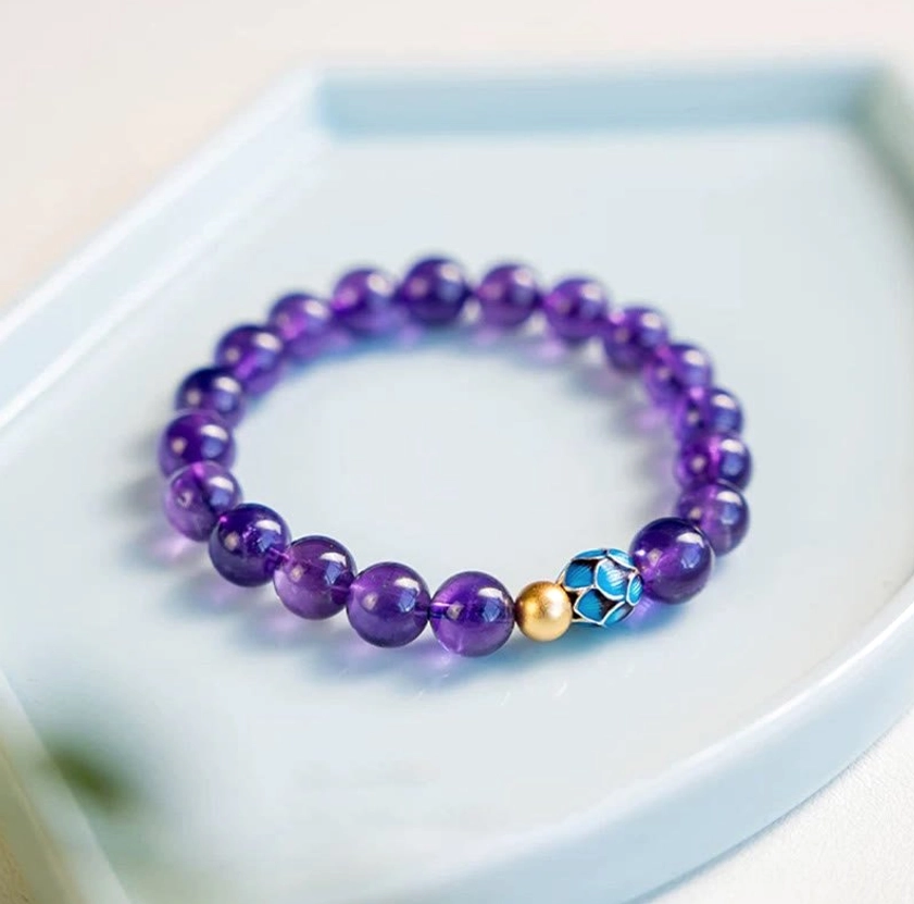 Natural amethyst lotus bracelet with 8mm purple crystal beads and copper spacer accents, premium quality display