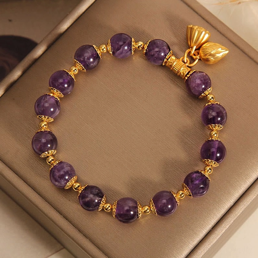 Amethyst lotus bracelet oblique view highlighting rear lotus pendant and gold metal fittings