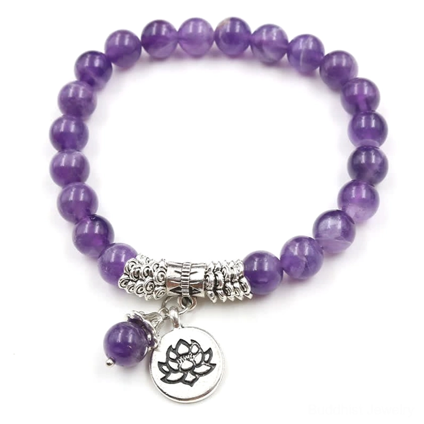 Amethyst lotus bracelet flat lay featuring purple amethyst beads with silver lotus charm on white background