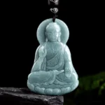 Amitabha Buddha jade lotus pendant necklace front view carved light cyan jade seated Buddha with halo on dark background