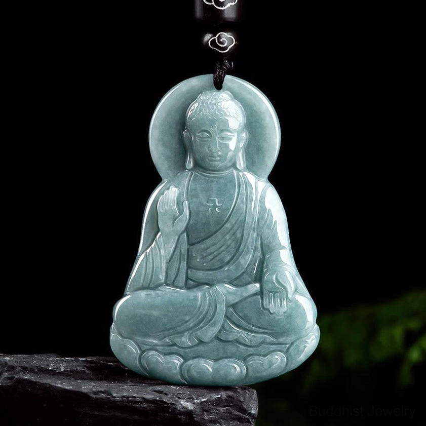 Amitabha Buddha jade lotus pendant necklace front view carved light cyan jade seated Buddha with halo on dark background