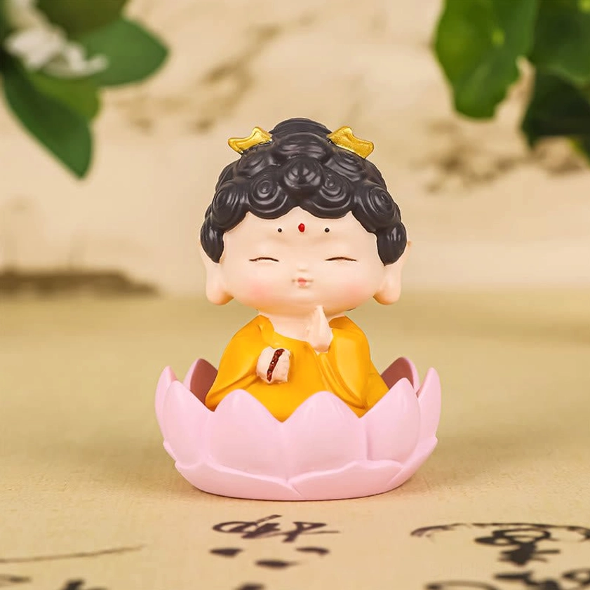 Sitting Amitabha Buddha resin statue with yellow monk robe, pink lotus flower base, and peaceful closed eyes on calligraphy background