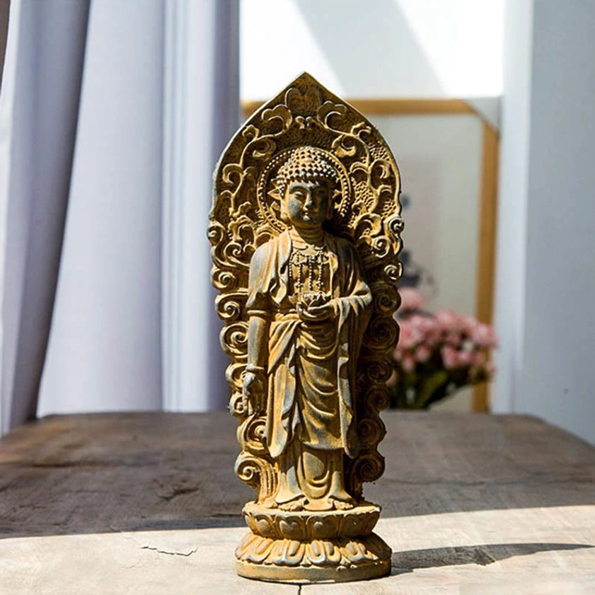 Amitabha Buddha statue with ornate carved backboard and traditional monk robes on wooden table with floral background, authentic Buddhist sculpture for altar