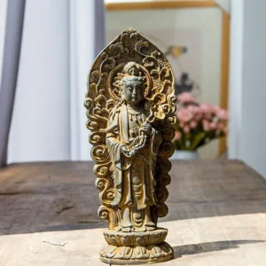 Handmade Amitabha Buddha trinity iron powder resin statue with rustic weathered patina finish, showcasing intricate carved backplate and ornate Buddhist iconography on wooden table