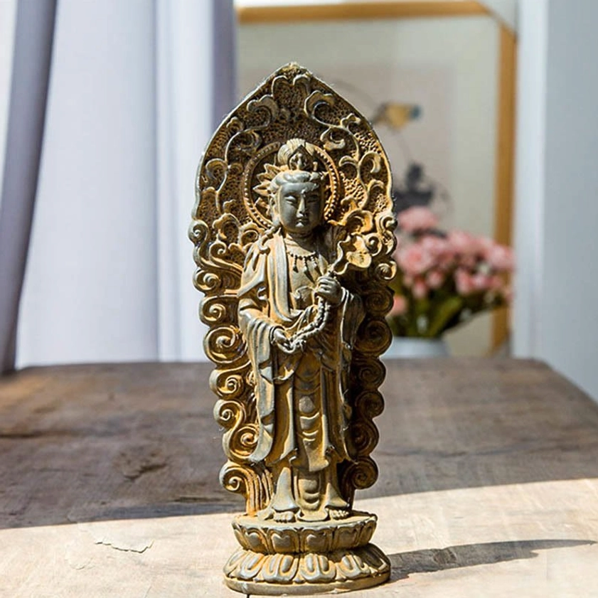 Handmade Amitabha Buddha trinity iron powder resin statue with rustic weathered patina finish, showcasing intricate carved backplate and ornate Buddhist iconography on wooden table