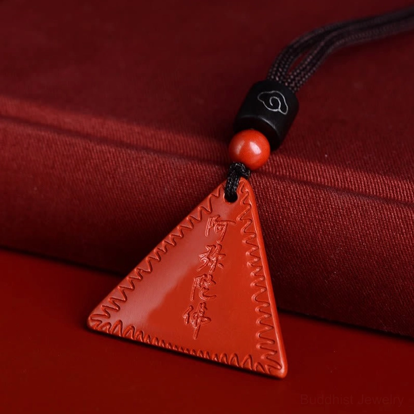 Red cinnabar Amitabha Buddhist pendant necklace with black beaded braided cord on red fabric box display